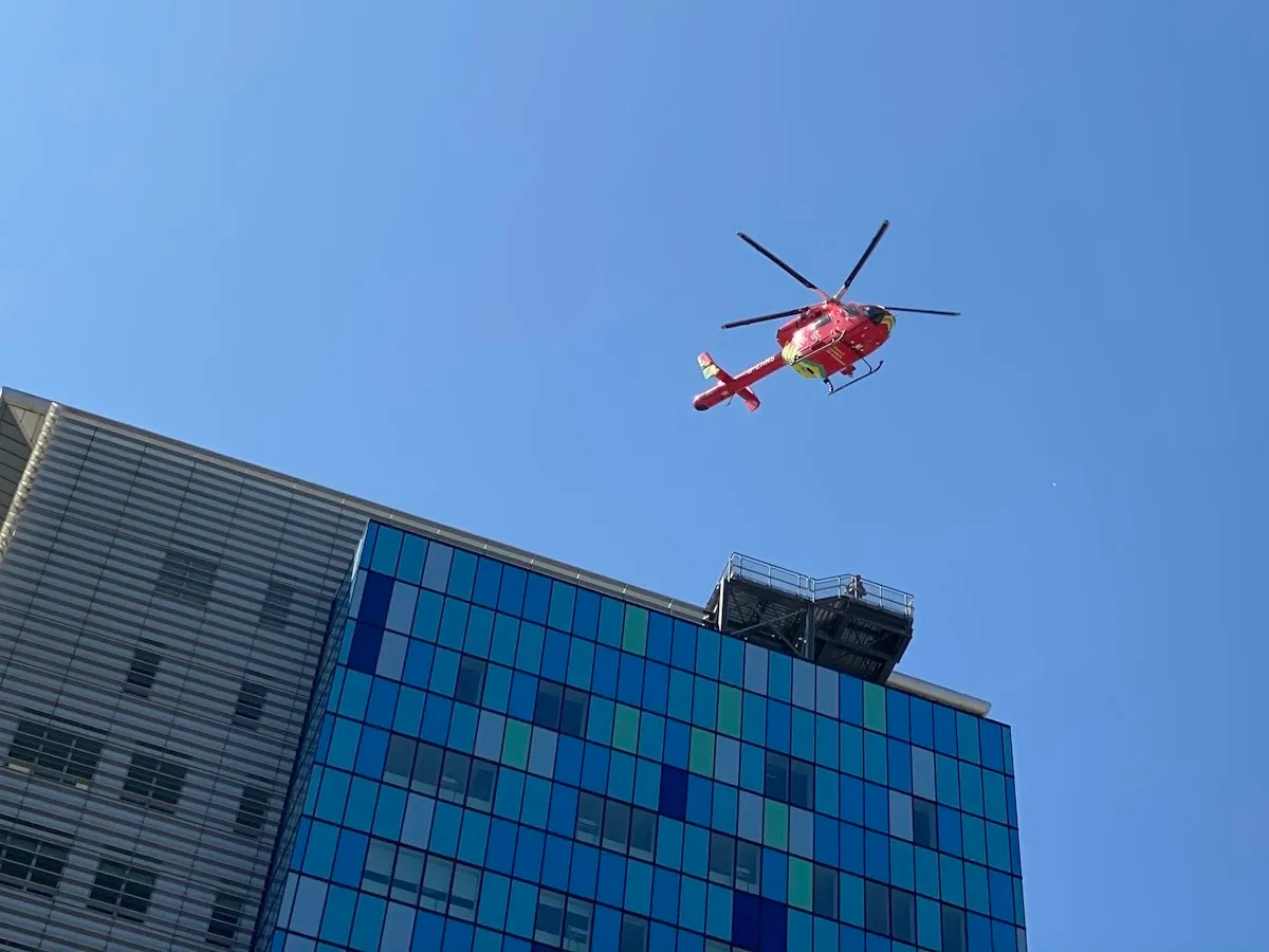 London's red air ambulance helicopter flying above the Royal London Hospital