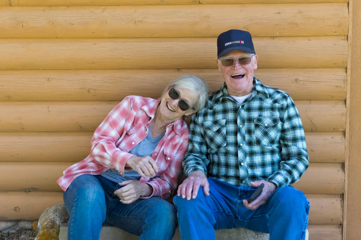 An older couple sitting together enjoying the countryside on a clear day