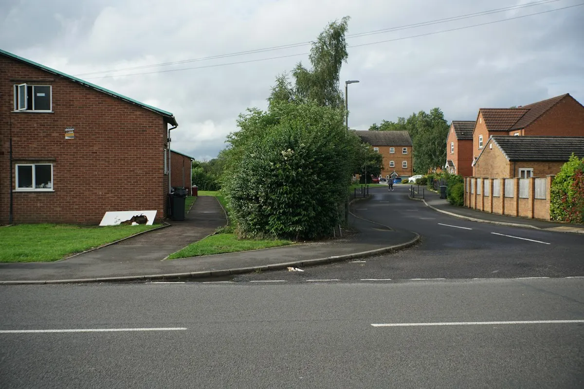 A quiet British housing estate with red-brick homes under a grey sky