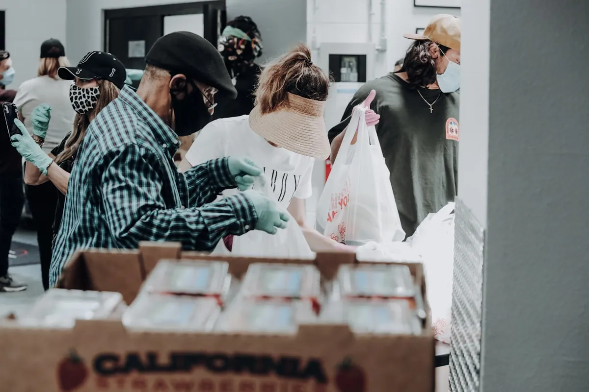 Volunteers gathered around boxes of donated food at a community food bank