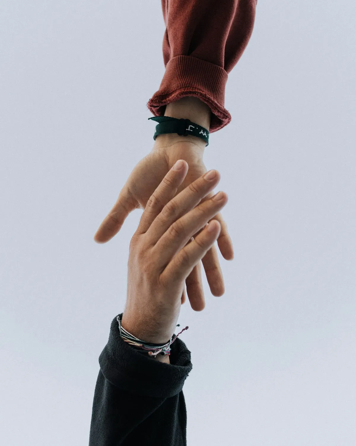 Two hands reaching toward one another in a gesture of help and support