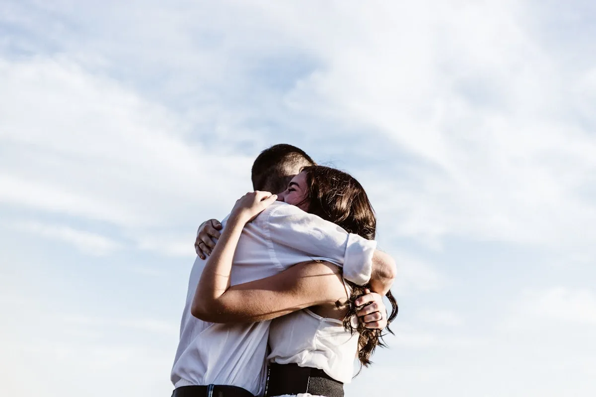 Two people sharing a warm, comforting hug