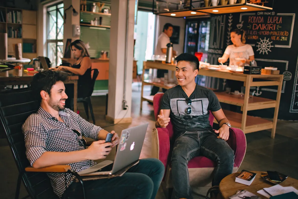 Two men sitting together, laughing and talking openly