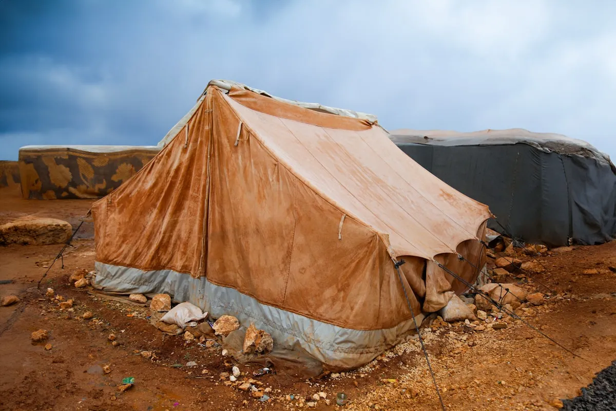 A humanitarian aid tent set up on open ground