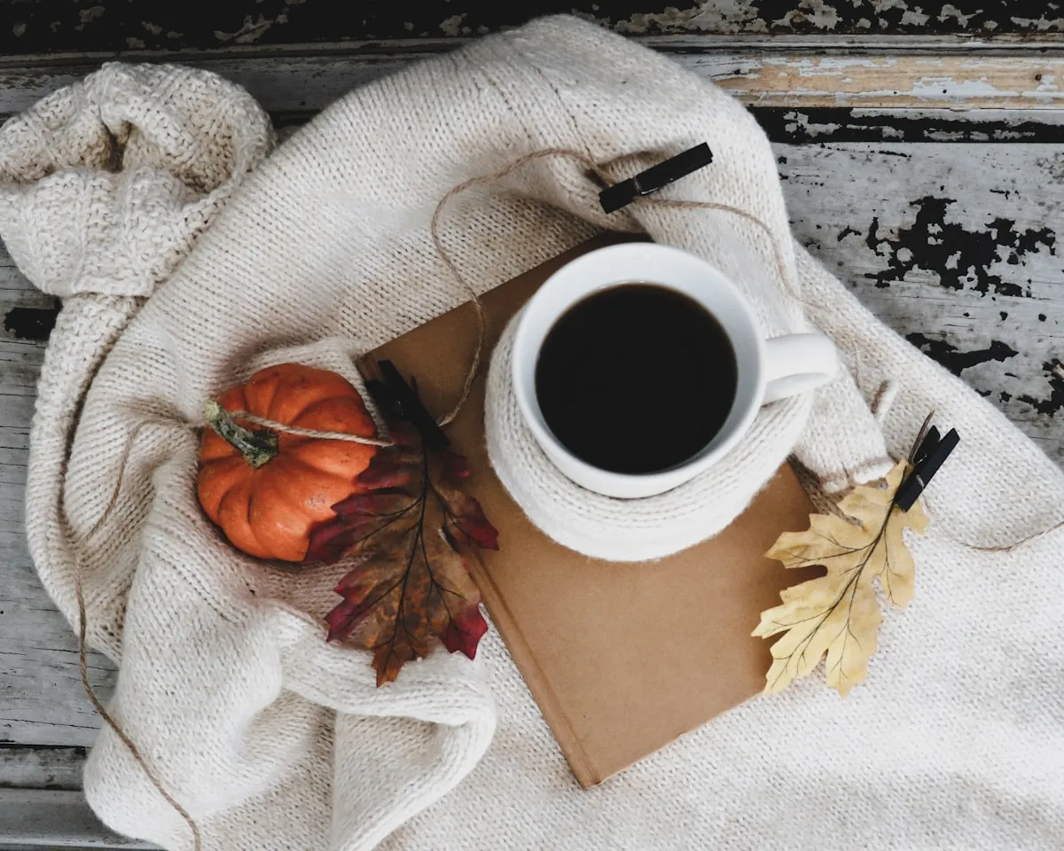 A white ceramic mug of tea resting by a window on a cosy afternoon